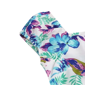 Detail of vintage floral dress showing elastic puff sleeves and colorful print texture