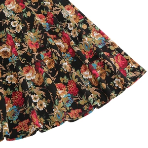 Detailed close-up of vintage floral print fabric on a black retro A-line midi skirt