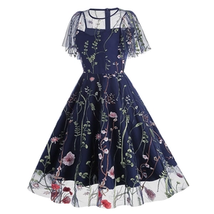 Detailed view of colorful floral vine embroidery on navy blue mesh evening dress
