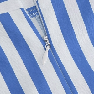 Detail view of the high-quality invisible zipper on a blue and white striped skirt fabric