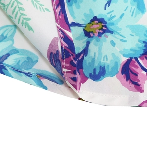 Detailed macro view of the floral print fabric and high-quality stitching on the vintage dress