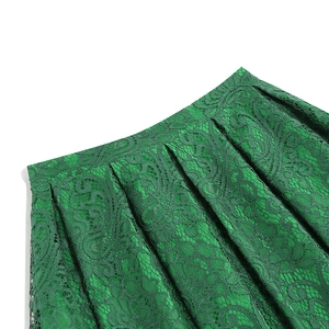 Detailed view of high waist green lace skirt showing intricate floral hollow patterns