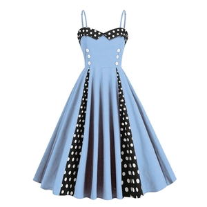Detail of light blue retro dress with polka dot panels and decorative white buttons