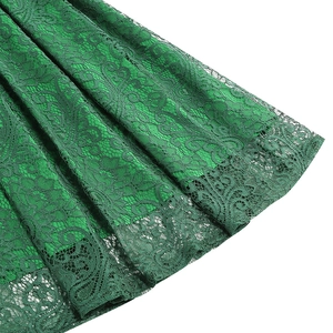 Detail of green lace skirt hem with floral embroidery and elegant scalloped edges
