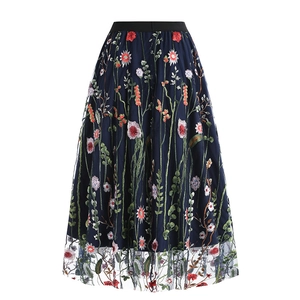 Close-up of colorful floral embroidery on navy blue mesh fabric of an A-line skirt