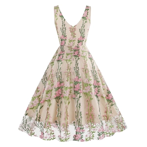 Close-up of elegant V-neck dress featuring delicate pink floral embroidery on beige tulle