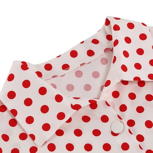 Detail of the vintage 1950s white dress featuring red polka dots and a lapel collar