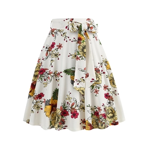 Detail of high-waist floral midi skirt featuring a bow-tie belt and vintage sunflower print