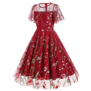 Detail of floral embroidery on red mesh party dress with exquisite needlework finish
