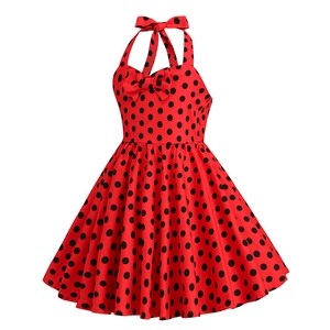 Detail of red polka dot girls' dress with halter neck and bow accent on white background