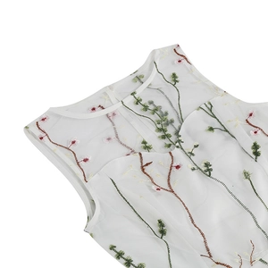 Detailed embroidery on white round neck dress featuring green vines and pink flowers