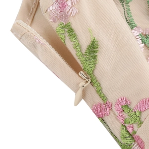 Close-up of invisible zipper and premium floral embroidery on V-neck vintage dress
