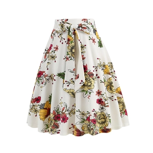 Detail of high waisted A-line skirt with colorful floral print and bow tie waist belt
