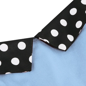 Detailed close-up of the light blue collar with contrasting black and white polka dot print