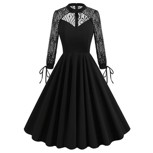 Detail of elegant black lace patchwork on long sleeves with ribbon bow cuffs