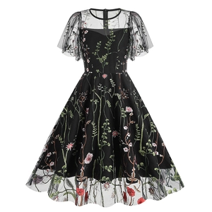Detailed close-up of intricate floral embroidery on black mesh retro evening dress