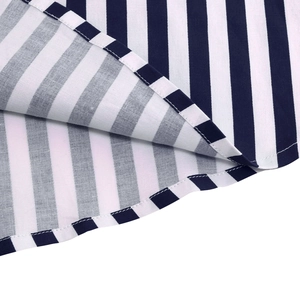 Detailed close-up showing precision stitching on blue and white striped skirt hemline