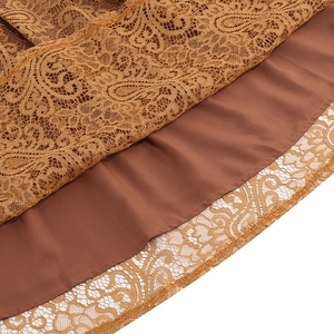 Macro detail of vintage lace skirt with paisley patterns and caramel satin lining