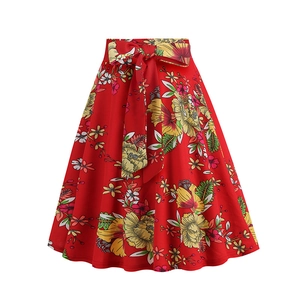 Detail of red floral A-line skirt featuring tropical prints and a bow-tie waist belt