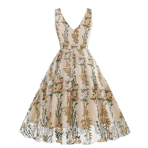 Close-up of vintage V-neck dress featuring delicate floral embroidery and mesh details