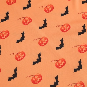 Detail shot of Halloween V-neck dress fabric with black bats and pumpkin prints