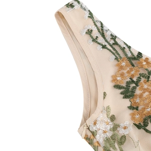 Close-up of floral embroidery on beige mesh fabric with a concealed side zipper