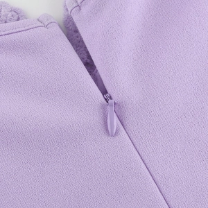 Close-up of seamless invisible zipper and delicate lace trim on light purple dress