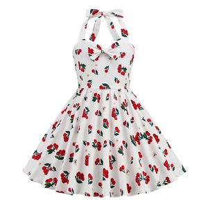 Detail of white girls' halter dress featuring red cherry print and neck bow decoration
