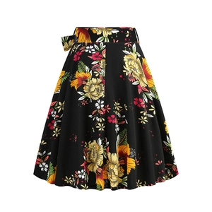 Detail of high-waisted black A-line skirt featuring vibrant floral prints and side bow tie
