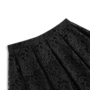 Detailed macro view of black vintage lace fabric with paisley floral patterns and pleats