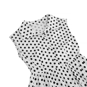 Detailed close-up of retro 1950s polka dot dress featuring shirt collar and button details