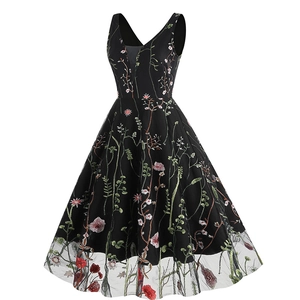 Detailed close-up of colorful floral embroidery on black V-neck retro A-line dress