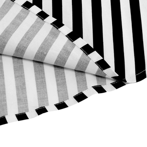 Detailed close-up of neat hem stitching on black and white striped cotton fabric