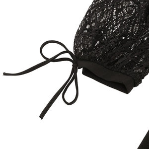 Detail of floral lace sleeve with delicate black ribbon tie and intricate mesh patterns