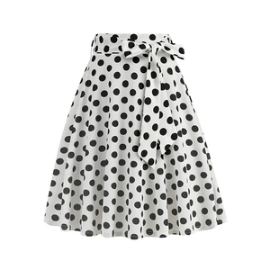 Detailed view of retro white A-line skirt with black polka dots and waist tie bow