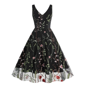 Detailed close-up of intricate floral embroidery on black vintage V-neck cocktail dress