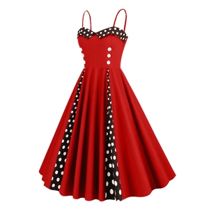 Close-up of retro 50s red dress featuring polka dot patchwork and button details