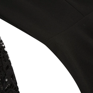 Detail of lace embroidery and premium black fabric seams on the back of the dress