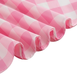 Elegant vintage pink gingham dress featuring soft textured fabric and detailed hemline