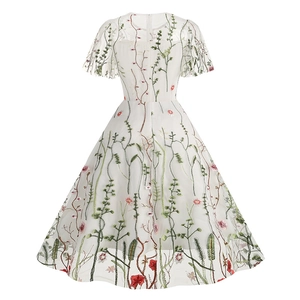 Detailed back view of vintage white dress with floral embroidery and hidden zipper