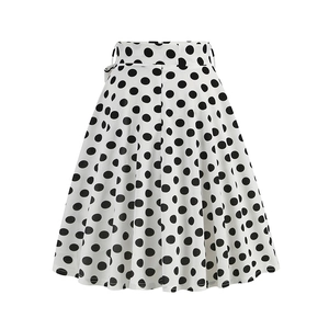 Close-up of vintage A-line skirt with black polka dots and high-waist bow tie detail