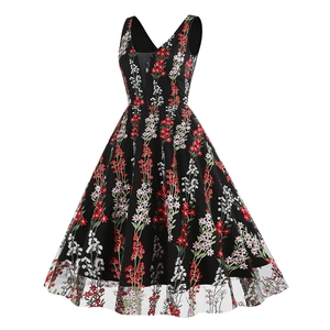Close-up of vintage V-neck sleeveless dress with floral embroidery on black mesh fabric