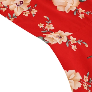 Detailed close-up of vintage floral print fabric on elegant red summer dress