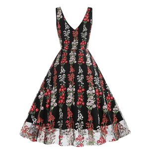 Detail view of the intricate floral embroidery and double-layer mesh hem on a V-neck dress