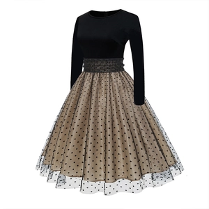 Detailed view of women's vintage tiered skirt with black polka dots and tulle overlay