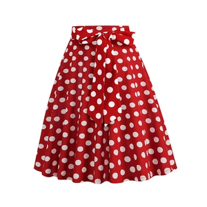 Detail of red polka dot skater skirt featuring a knotted bow tie waist and retro print