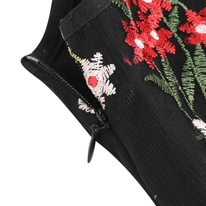 Detail of floral embroidery on black mesh fabric with a concealed invisible zipper