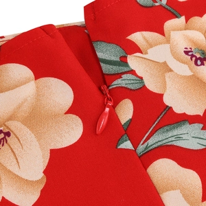 Detailed close-up of a high-quality red floral dress featuring a hidden zipper closure