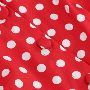 Detail of red polka dot fabric with fabric-covered buttons on vintage cocktail dress