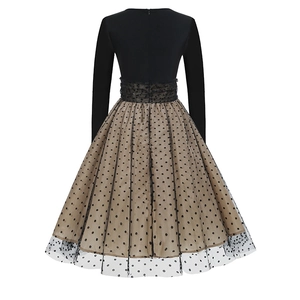 Back view of a vintage polka dot dress with long sleeves and a hidden zipper closure